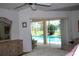 Bright primary bedroom featuring a pool view, ceiling fan, and charming dresser at 76 Sportsman Rd, Rotonda West, FL 33947