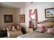 Comfortable bedroom with a side chair, lamp, and framed pictures at 76 Sportsman Rd, Rotonda West, FL 33947