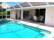 Relaxing pool area with a screened-in lanai, perfect for outdoor entertaining at 76 Sportsman Rd, Rotonda West, FL 33947