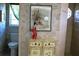 Powder room with decorative wallpaper and a statue at 76 Sportsman Rd, Rotonda West, FL 33947