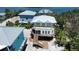 Aerial view of a charming coastal home with expansive decks and nearby waterways at 8152 Little Gasparilla Is, Placida, FL 33946