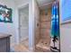 Bathroom featuring a tiled shower with glass door and a coastal-themed shower curtain at 8152 Little Gasparilla Is, Placida, FL 33946