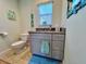 Well-lit bathroom with a single sink vanity, tile floors, and coastal themed decor at 8152 Little Gasparilla Is, Placida, FL 33946