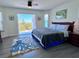 Bright bedroom featuring a king bed, access to an outdoor patio, and a stylish octopus rug on top of hard wood floors at 8152 Little Gasparilla Is, Placida, FL 33946