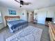 Bright bedroom featuring a king bed, closet, hardwood floors, ceiling fan, and tastefully-designed decor at 8152 Little Gasparilla Is, Placida, FL 33946