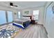 Bright bedroom with a king size bed, light wood floors and access to a balcony at 8152 Little Gasparilla Is, Placida, FL 33946