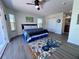 Bright bedroom showcasing a spacious layout with hardwood floors, closet, and decoratively designed rug underneath a ceiling fan at 8152 Little Gasparilla Is, Placida, FL 33946