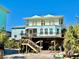 Charming coastal home on stilts with a spacious porch and beautiful exterior paint at 8152 Little Gasparilla Is, Placida, FL 33946