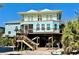 Stunning elevated coastal home featuring a spacious porch and outdoor living space at 8152 Little Gasparilla Is, Placida, FL 33946
