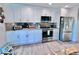 Kitchen featuring white cabinets, stainless steel appliances, and stone countertops at 8152 Little Gasparilla Is, Placida, FL 33946