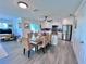 Eat-in kitchen with dining table and seating, a kitchen island and stainless appliances at 8152 Little Gasparilla Is, Placida, FL 33946