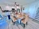 Bright and airy kitchen featuring white cabinets, granite countertops, and adjacent dining area at 8152 Little Gasparilla Is, Placida, FL 33946