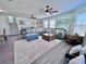 Bright and airy living room featuring a large sectional sofa, ceiling fans, and ample natural light at 8152 Little Gasparilla Is, Placida, FL 33946