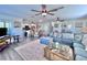 Open-concept living room flowing into a kitchen and dining area, with stairs leading to an upper level at 8152 Little Gasparilla Is, Placida, FL 33946
