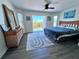 Inviting bedroom with water view access, rattan accents, and coastal decor at 8152 Little Gasparilla Is, Placida, FL 33946