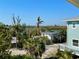 Idyllic neighborhood scene with lush palm trees and glimpses of the serene waterway at 8152 Little Gasparilla Is, Placida, FL 33946