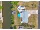 Aerial view of waterfront property with a dock, a canal, a patio and a neatly landscaped yard at 832 E 4Th St, Englewood, FL 34223