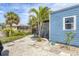 Lush backyard with palm trees, a blue shed, rock garden, and a well-maintained lawn at 832 E 4Th St, Englewood, FL 34223
