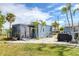 Picturesque backyard featuring a shed with a black privacy screen, a barbecue grill, and palm trees at 832 E 4Th St, Englewood, FL 34223