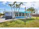 Spacious backyard with a grill, shade cover, hammock, and well-maintained lawn, ideal for outdoor activities at 832 E 4Th St, Englewood, FL 34223