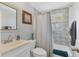Bathroom featuring a vanity, toilet, and bathtub with tiled walls and a shower curtain at 832 E 4Th St, Englewood, FL 34223