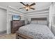 Comfortable bedroom with a bed, dresser, and mounted TV for cozy nights at 832 E 4Th St, Englewood, FL 34223