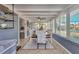 Bright sunroom dining area featuring a ceiling fan, tile flooring, and lots of natural light at 832 E 4Th St, Englewood, FL 34223