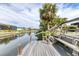Canal-front dock features a staircase leading to the water, offering serene views and waterfront access at 832 E 4Th St, Englewood, FL 34223