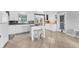 Bright kitchen with white cabinets, an island with seating, and modern appliances at 832 E 4Th St, Englewood, FL 34223