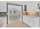 A bright kitchen view showcases white cabinets and a seamless transition to the dining area at 832 E 4Th St, Englewood, FL 34223
