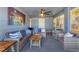 Enclosed lanai boasts an open-air design with a ceiling fan and comfortable seating for relaxing and entertaining at 832 E 4Th St, Englewood, FL 34223