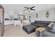 Open-concept living room with tile flooring, a ceiling fan, and a gray sectional sofa at 832 E 4Th St, Englewood, FL 34223
