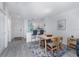Open dining area with wood table and kitchen bar, featuring gray accent rug and stainless steel appliances at 8407 Placida Rd # 205, Placida, FL 33946