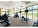 Well-equipped fitness center with cardio machines, weights, and large windows for natural light at 8407 Placida Rd # 205, Placida, FL 33946