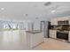 Open floor plan showcasing living room, kitchen, and water views through sliding glass doors at 918 Edgewater Dr, Englewood, FL 34223