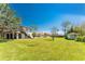 Expansive backyard featuring a deck, manicured lawn, and separate additional building at 941 Allen Ave, Englewood, FL 34223