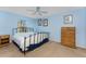 Light and airy bedroom with blue walls, a ceiling fan, and ample natural light at 941 Allen Ave, Englewood, FL 34223