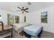 Bright bedroom featuring two beds, ample natural light, and a sliding door leading to a balcony at 941 Allen Ave, Englewood, FL 34223