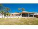 Charming home exterior showcasing a spacious screened porch perfect for outdoor living, lush greenery, and serene views at 941 Allen Ave, Englewood, FL 34223