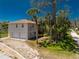 Beautiful home with a two-car garage, surrounded by lush greenery and towering palm trees at 941 Allen Ave, Englewood, FL 34223