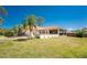 Inviting home exterior with a screen enclosed porch, lush greenery, and a well-manicured lawn at 941 Allen Ave, Englewood, FL 34223