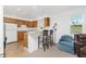 Open kitchen area with modern bar seating, adjacent to a cozy living space at 941 Allen Ave, Englewood, FL 34223