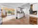 Bright kitchen with white cabinets, stainless steel appliances, and earth-tone flooring, leading to a screened lanai at 941 Allen Ave, Englewood, FL 34223