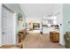 Open-concept living room and kitchen with white cabinetry and earth tone flooring, offering a seamless flow for entertaining at 941 Allen Ave, Englewood, FL 34223