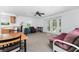 Bright living space with a kitchenette, dining area, and access to an outdoor balcony for seamless indoor-outdoor living at 941 Allen Ave, Englewood, FL 34223