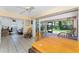 Bright living space with tile floors, ceiling fan, and access to a screened-in porch with backyard view at 941 Allen Ave, Englewood, FL 34223