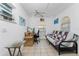 Cozy office featuring tile floors, ceiling fan, arched windows, and a comfortable futon at 941 Allen Ave, Englewood, FL 34223