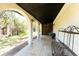 Covered patio with arched supports, offering a shady outdoor space and views of the yard at 941 Allen Ave, Englewood, FL 34223