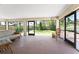 Screened patio with seating and views of the green backyard, perfect for enjoying the outdoors at 941 Allen Ave, Englewood, FL 34223