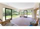 Spacious screened patio with seating, offering a great view of the green yard and adjacent buildings at 941 Allen Ave, Englewood, FL 34223
